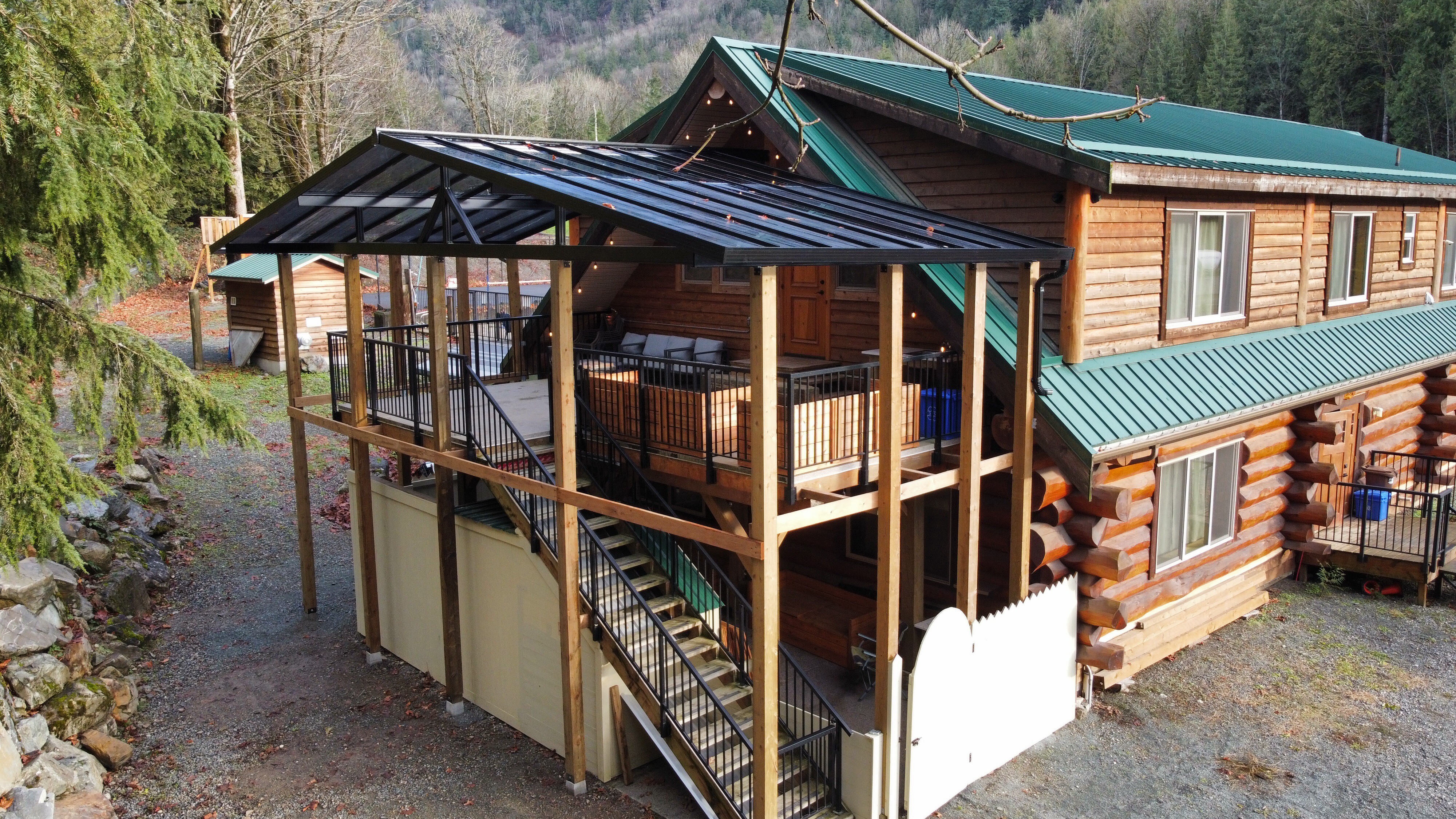 The log lodge from above, with its covered glass-roofed deck