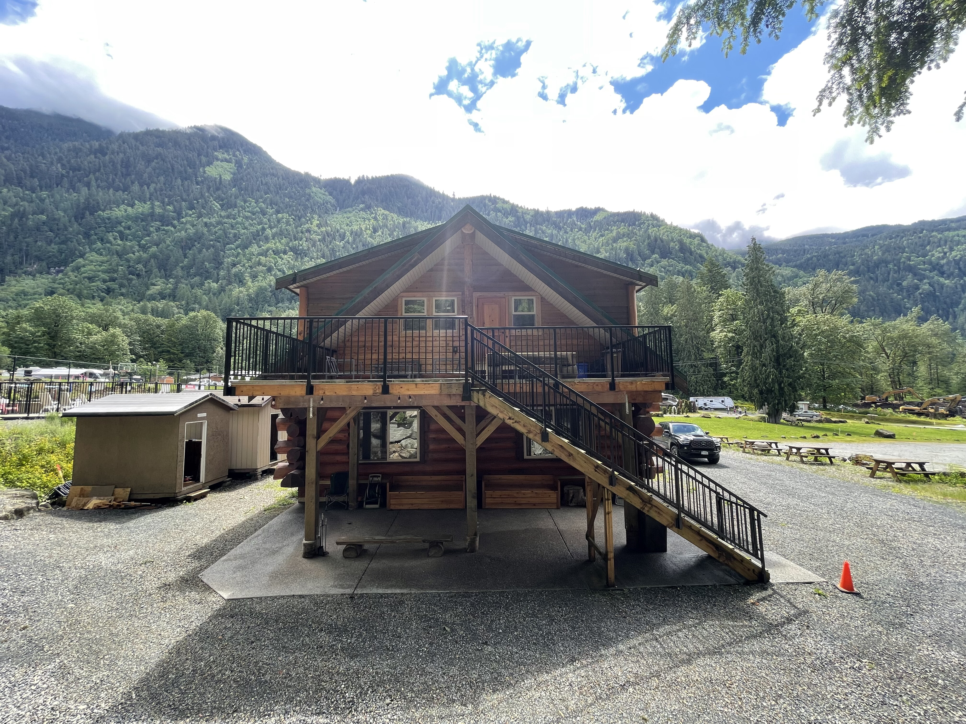 The lodge stairs and deck with clouds on the mountain behind