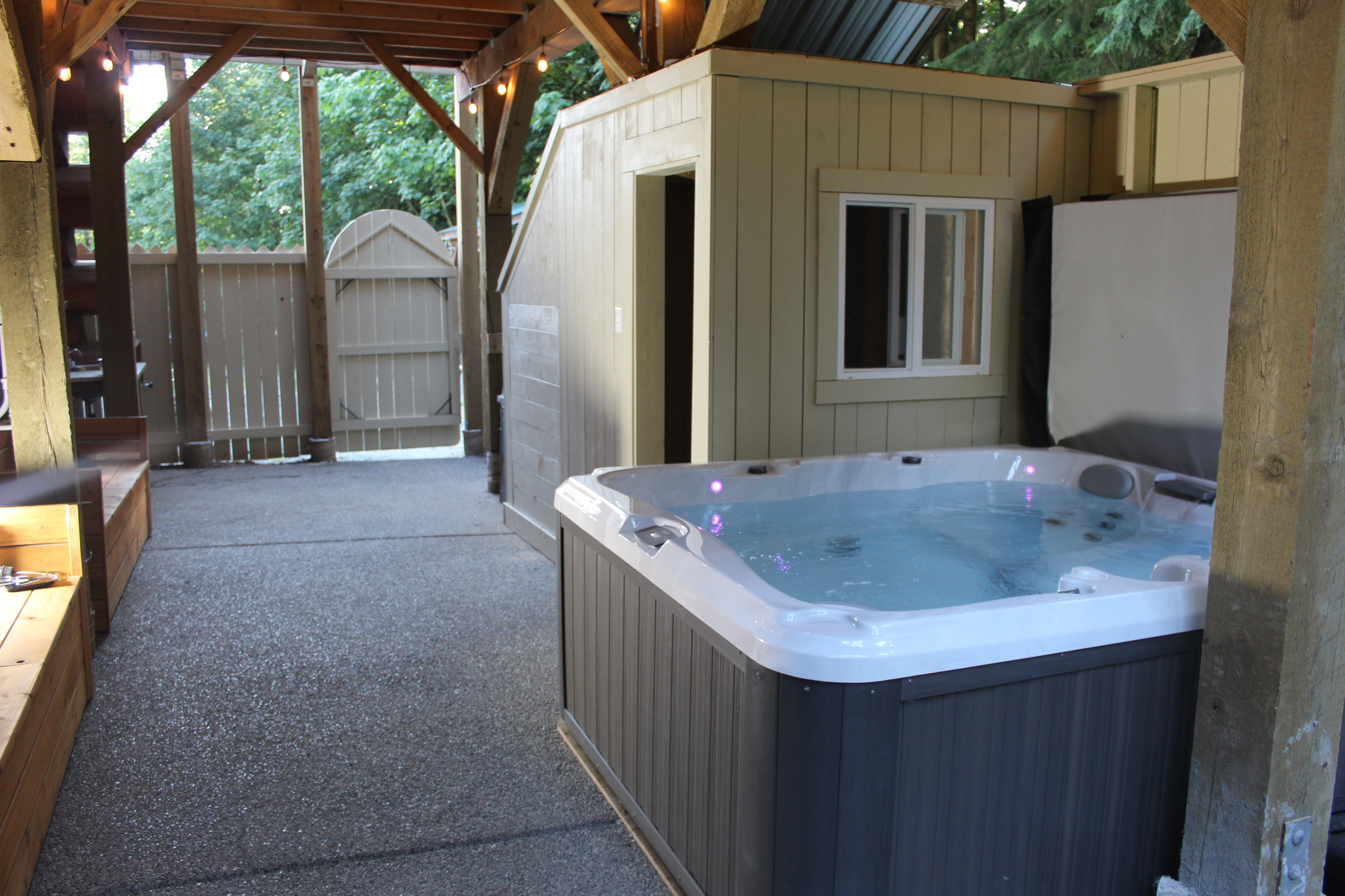 The covered hot tub on the lodge deck