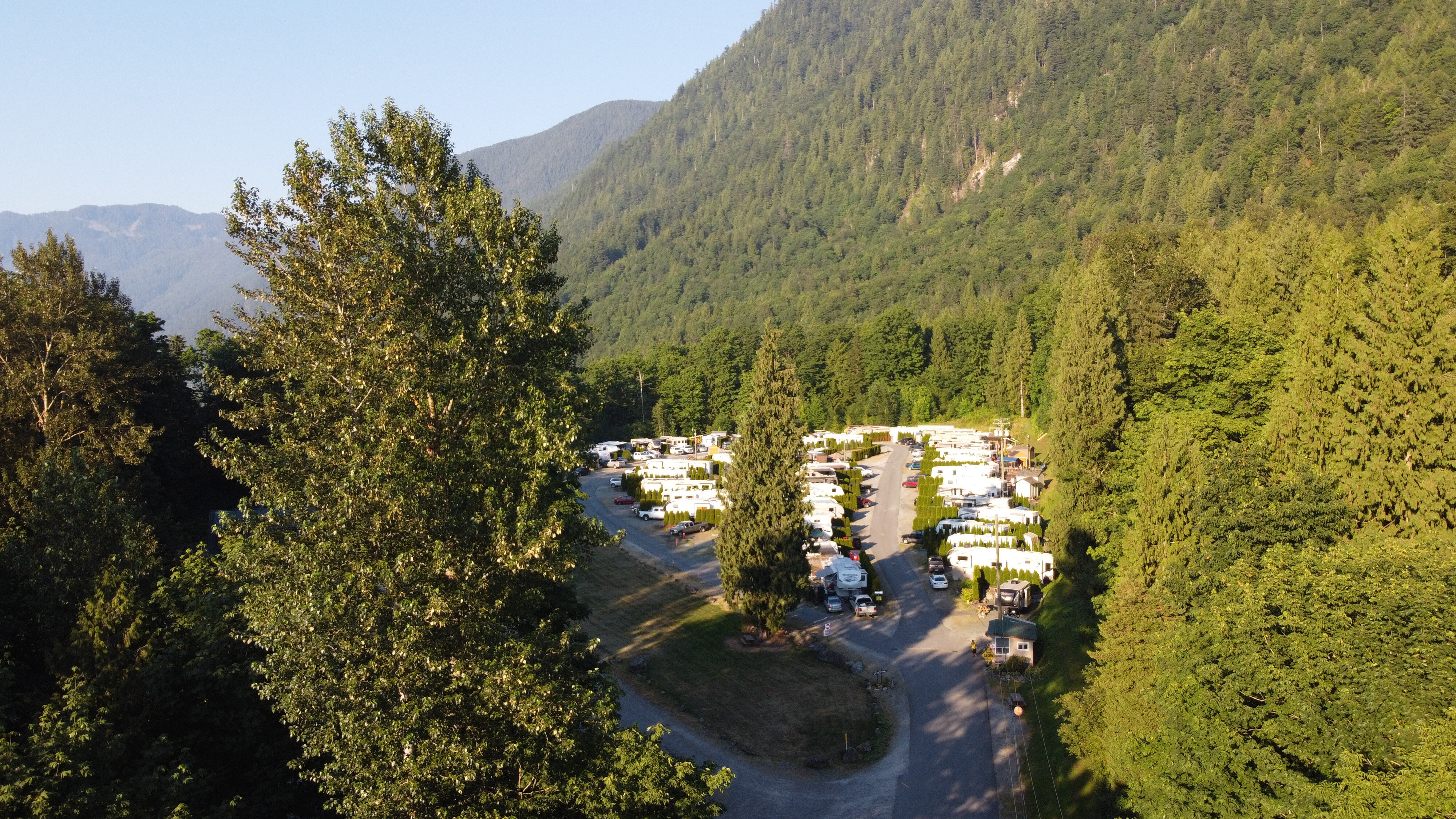 RV sites in a forest clearing with the Cheam range rising behind