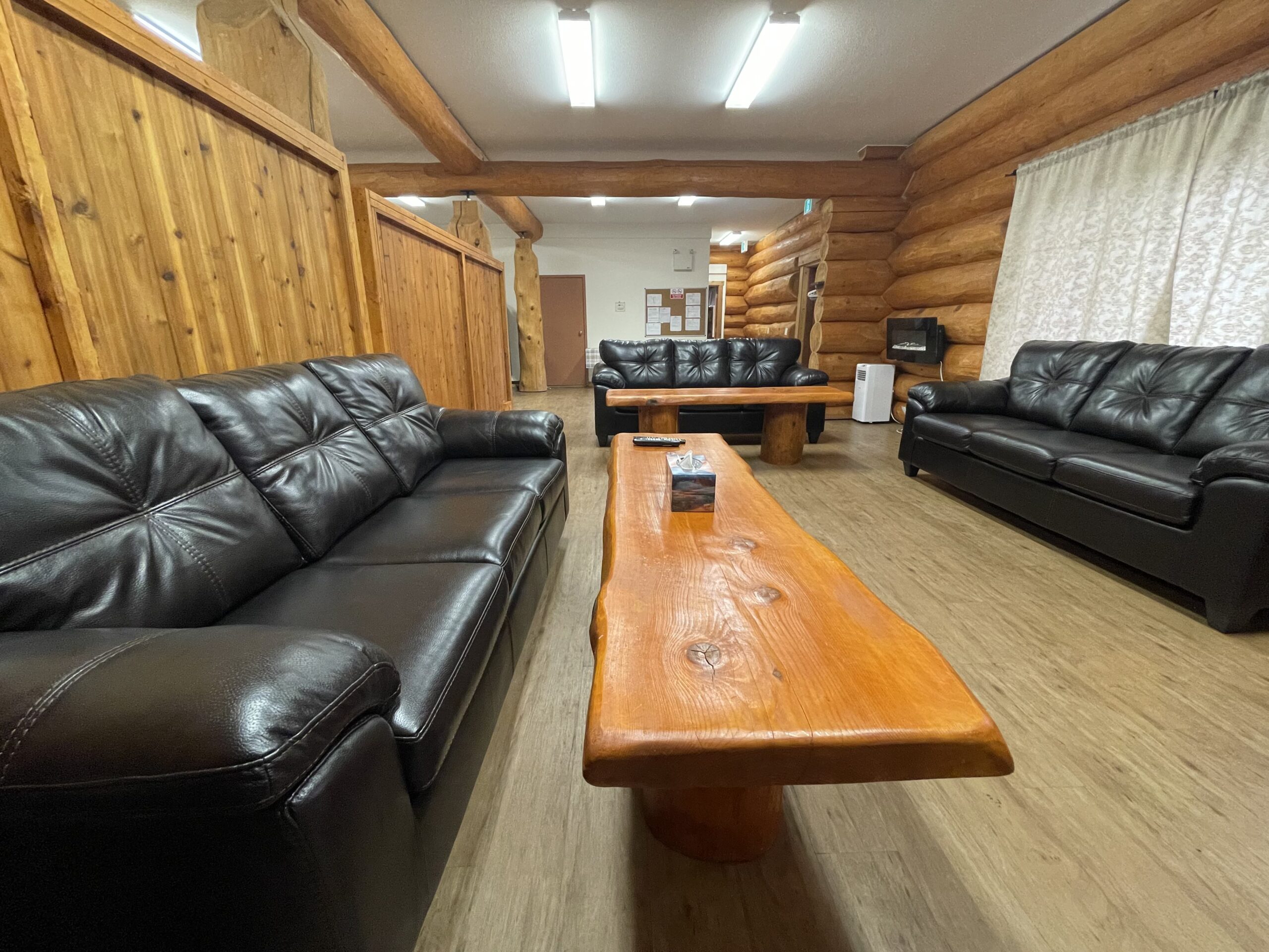 Leather sofas and a live-edge table in the lodge common room